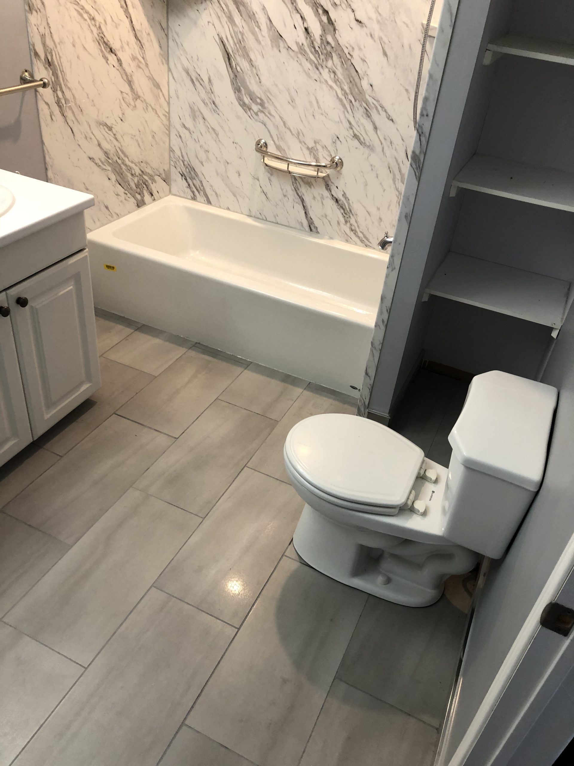 photo of newly renovated bathtub, toilet and floor
