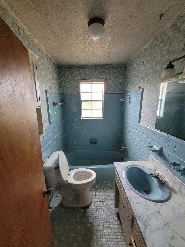 photo of an old blue themed bathroom