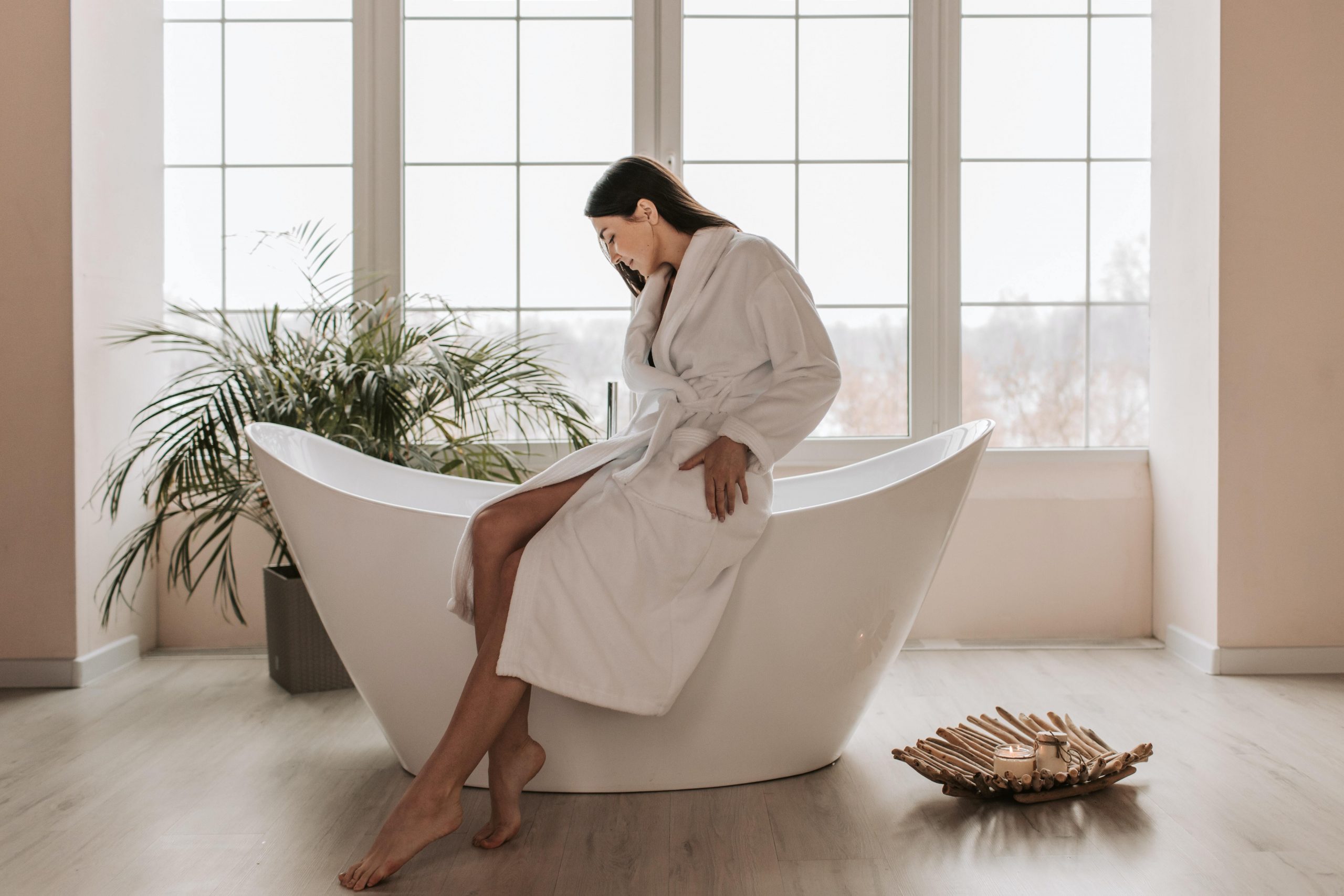 woman sitting on bathtub